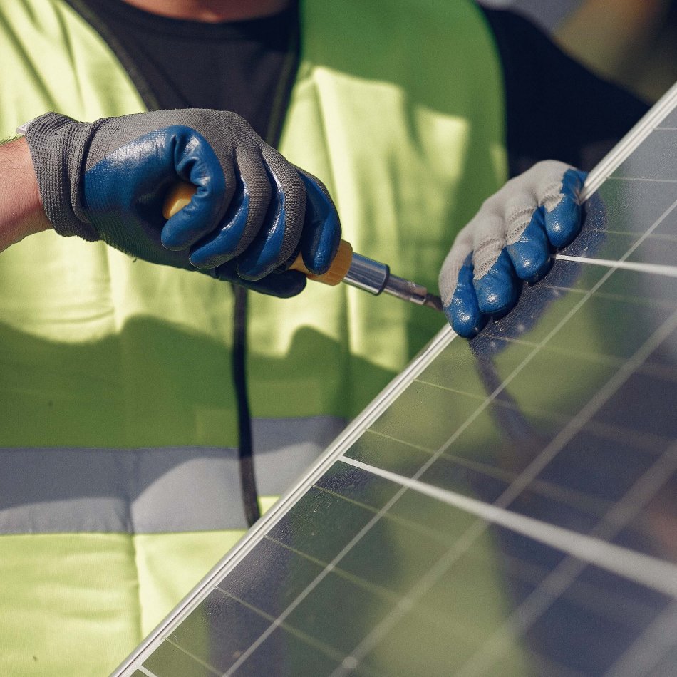 Engineer fitting solar with screwdriver